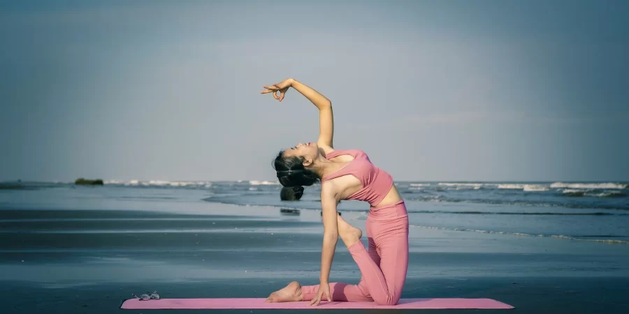 Woman doing yoga on the beach